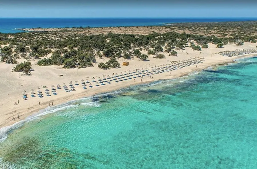 Wide exotic shoreline with golden sand and bright turquoise sea at Chrissi Island